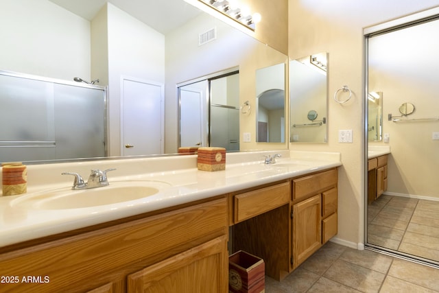 bathroom with tile patterned flooring, vanity, and a shower with shower door