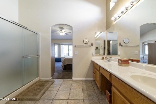 bathroom with tile patterned flooring, vanity, ceiling fan, and walk in shower