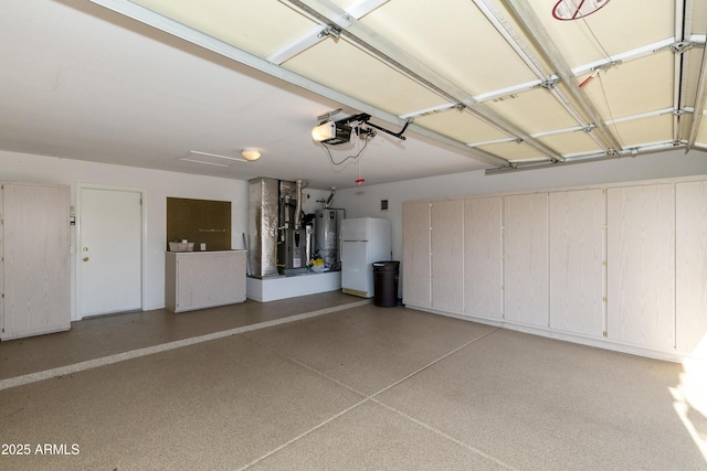 garage with a garage door opener, washer and clothes dryer, water heater, and white fridge