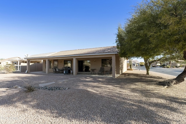 back of property with a patio