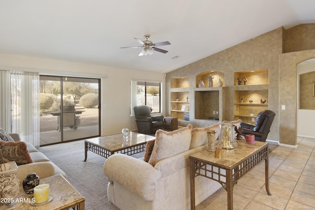 tiled living room with ceiling fan, lofted ceiling, and built in features