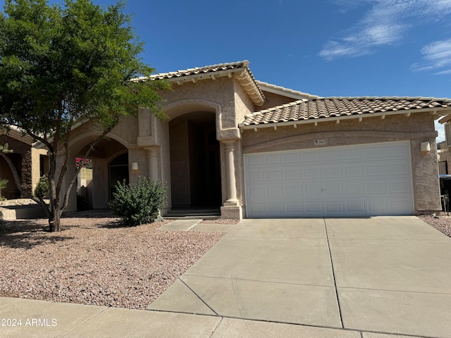 mediterranean / spanish-style home featuring a garage