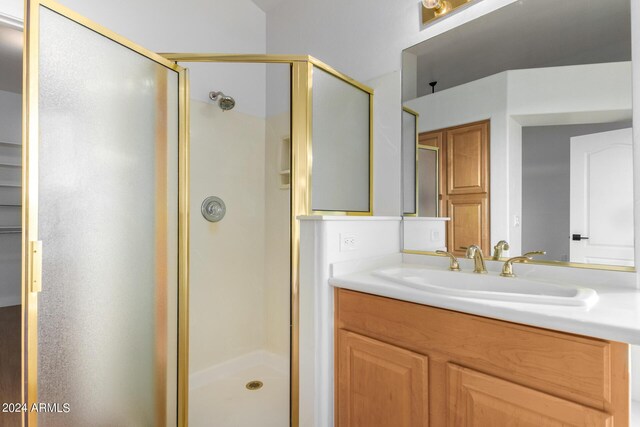 bathroom with vaulted ceiling, wood-type flooring, plus walk in shower, and vanity