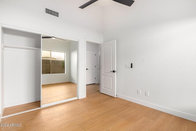 spare room featuring vaulted ceiling, light hardwood / wood-style flooring, and ceiling fan