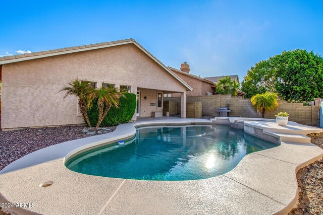 view of pool featuring a patio area and an in ground hot tub