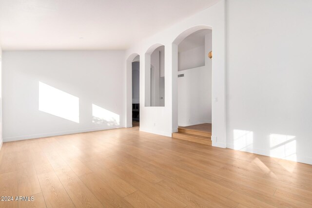 kitchen featuring a center island, light hardwood / wood-style floors, ceiling fan, black appliances, and high vaulted ceiling