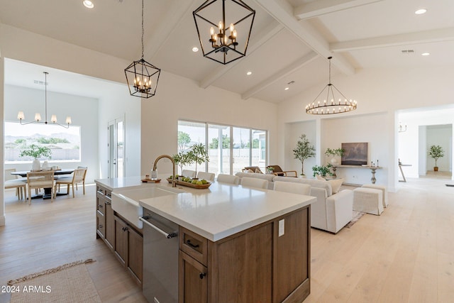 kitchen with dishwasher, decorative light fixtures, and light hardwood / wood-style floors