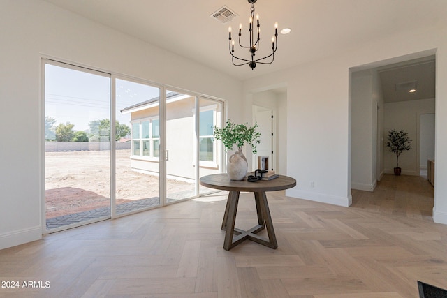 unfurnished dining area with an inviting chandelier and light parquet floors