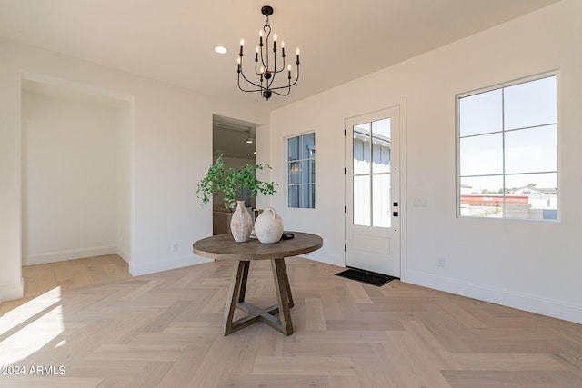 entryway featuring an inviting chandelier and light parquet floors