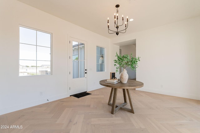 entryway featuring light parquet floors and a notable chandelier