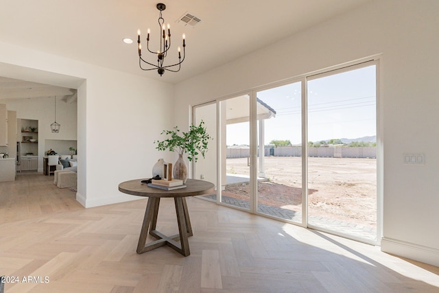 interior space with a notable chandelier and parquet flooring