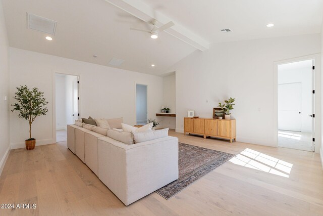 living room featuring ceiling fan, vaulted ceiling with beams, and light hardwood / wood-style floors