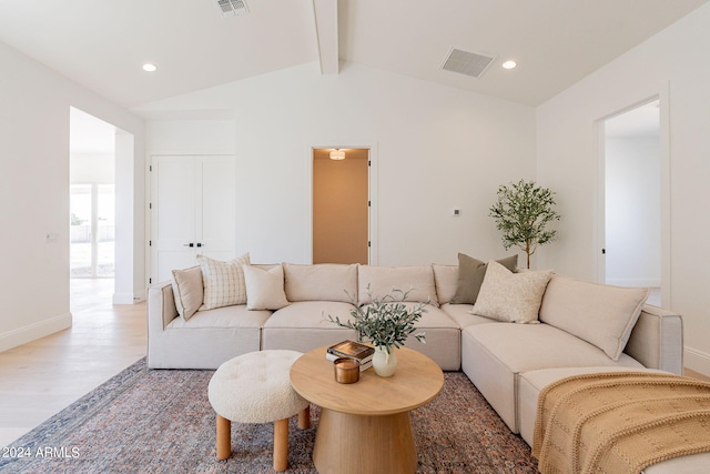 living room featuring lofted ceiling with beams and hardwood / wood-style floors