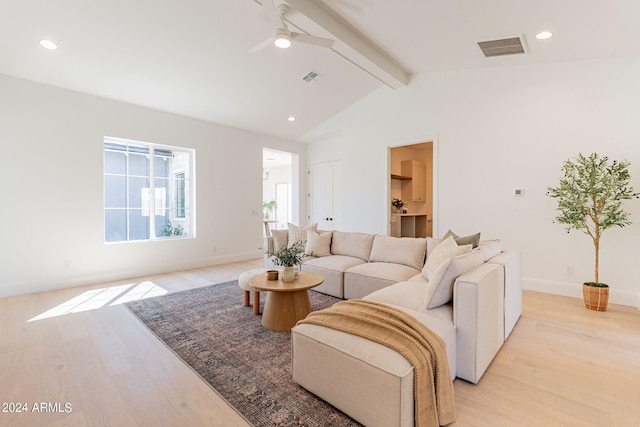 living room featuring ceiling fan, vaulted ceiling with beams, and light hardwood / wood-style floors