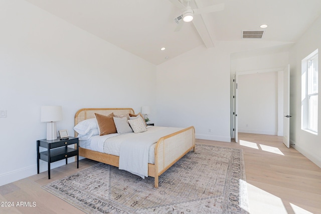 bedroom featuring light hardwood / wood-style floors, lofted ceiling with beams, and ceiling fan