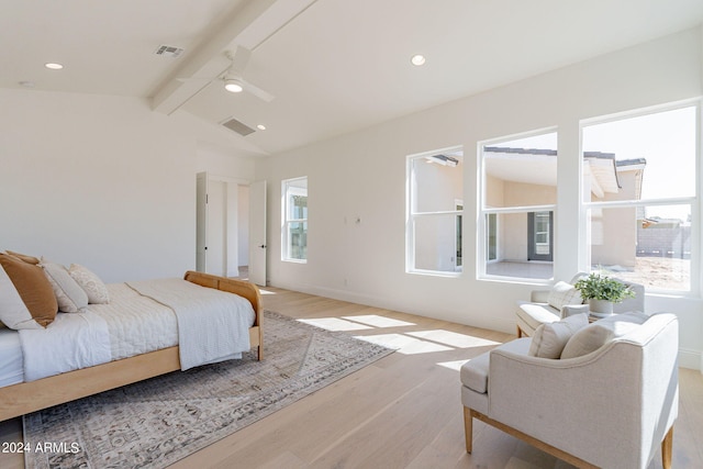 bedroom with vaulted ceiling with beams, light hardwood / wood-style flooring, and multiple windows