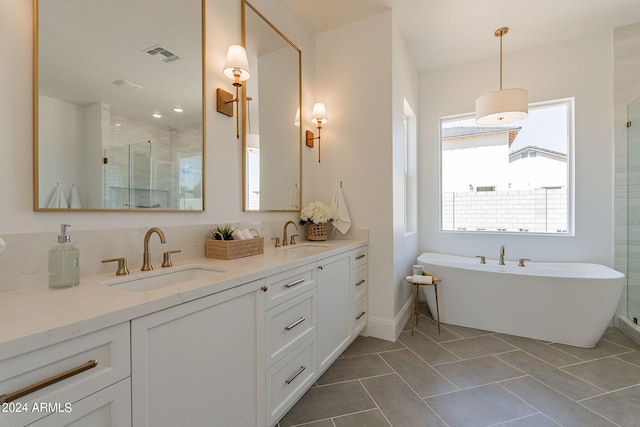 bathroom featuring tile patterned floors, vanity, and separate shower and tub