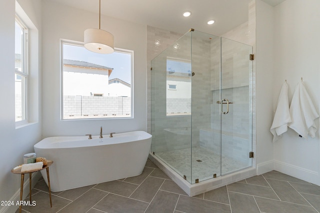 bathroom featuring tile patterned flooring and plus walk in shower