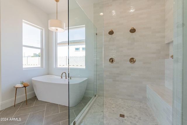 bathroom featuring plus walk in shower and tile patterned floors