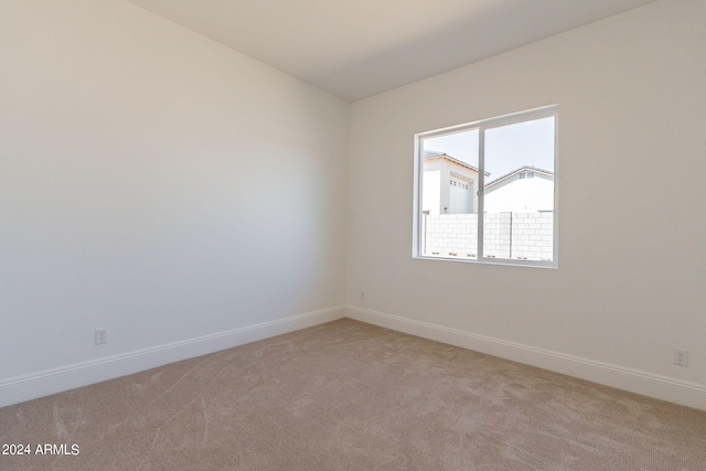 spare room with light colored carpet