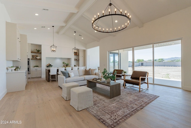 living room featuring a notable chandelier, plenty of natural light, and light hardwood / wood-style floors