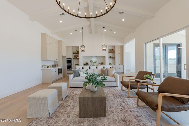 living room with high vaulted ceiling, an inviting chandelier, beamed ceiling, and light hardwood / wood-style flooring