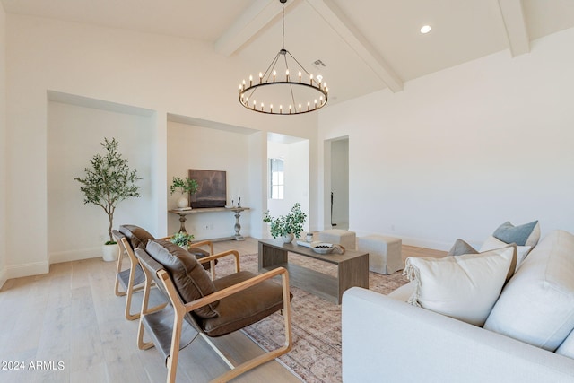 living room with vaulted ceiling with beams, light hardwood / wood-style flooring, and a chandelier