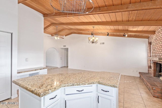 1316 N Spring Cir, Mesa, AZ 85203 - kitchen with wooden ceiling, a brick fireplace, white cabinets, and light tile patterned floors