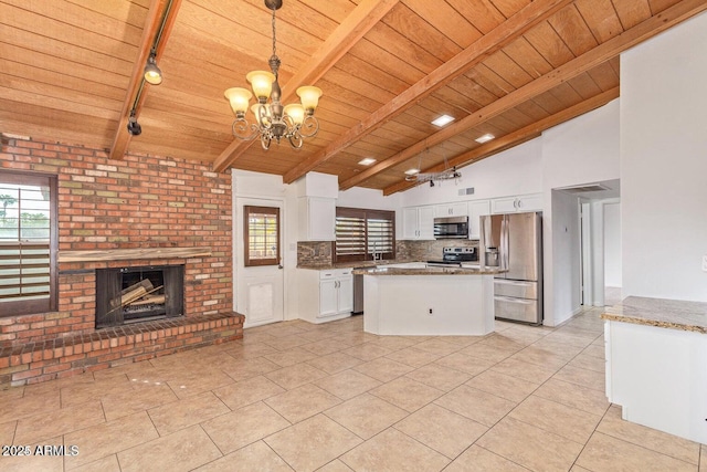 1316 N Spring Cir, Mesa, AZ 85203 - kitchen with white cabinets, light tile patterned floors, stainless steel appliances, wooden ceiling, and a notable chandelier