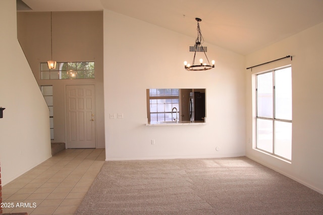 interior space with light carpet, visible vents, a chandelier, high vaulted ceiling, and light tile patterned flooring