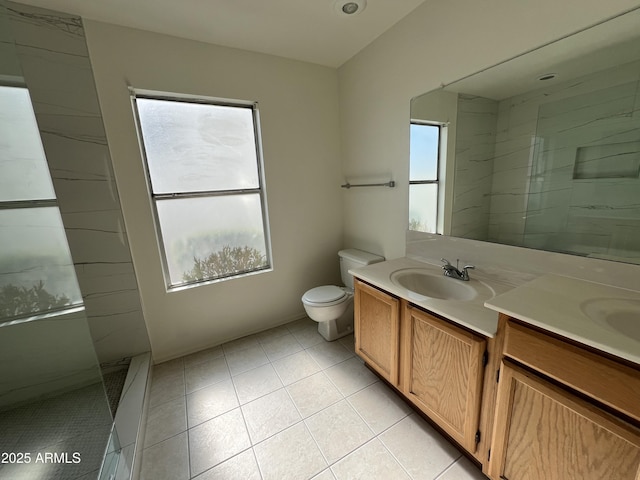 full bathroom with double vanity, toilet, a sink, a walk in shower, and tile patterned flooring