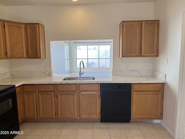 kitchen featuring black appliances, brown cabinets, and a sink