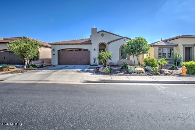 mediterranean / spanish-style house featuring a garage