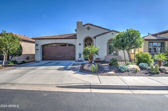 mediterranean / spanish-style home with a garage