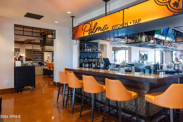 bar featuring concrete flooring