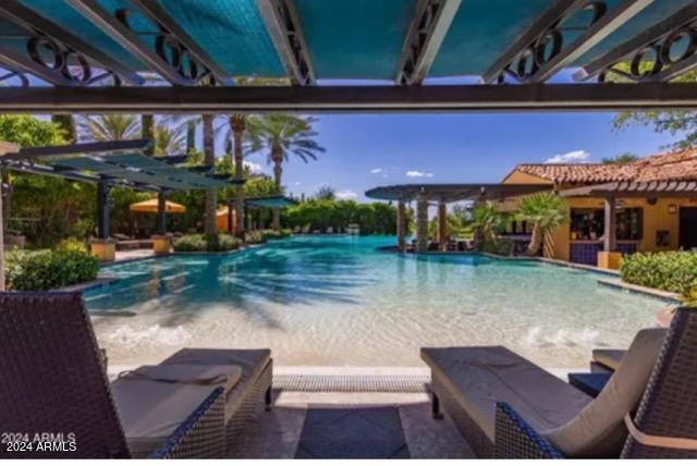 view of pool with a pergola and a patio area