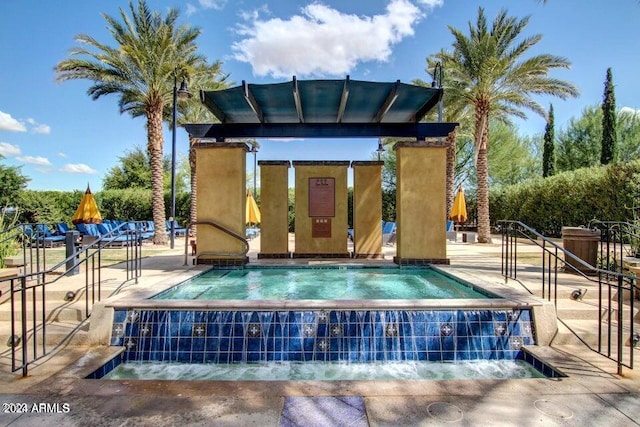 view of swimming pool with pool water feature and a patio area