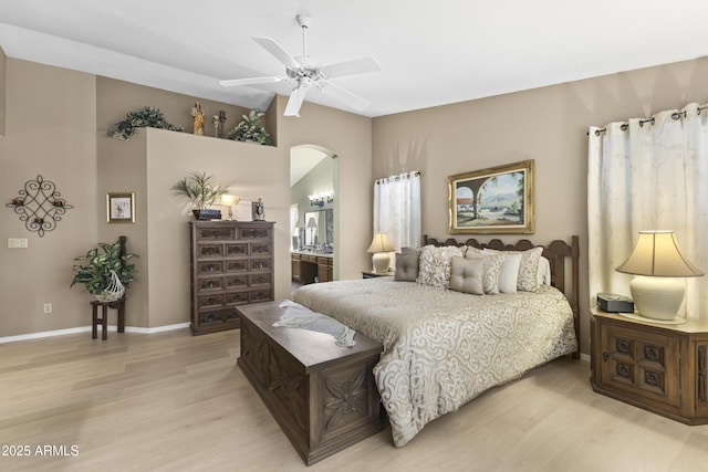 1449 W Sherri Dr, Gilbert, AZ 85233 - bedroom featuring light wood finished floors, arched walkways, a ceiling fan, and connected bathroom