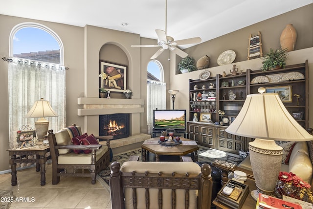 1449 W Sherri Dr, Gilbert, AZ 85233 - living room featuring a tiled fireplace, ceiling fan, and tile patterned floors