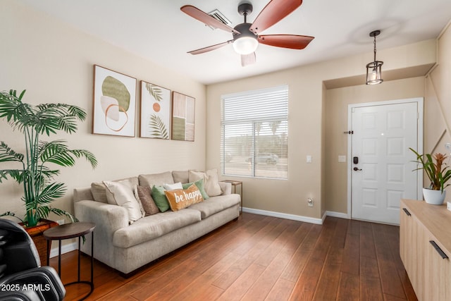 living room with dark hardwood / wood-style floors and ceiling fan