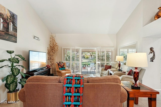 living area with high vaulted ceiling