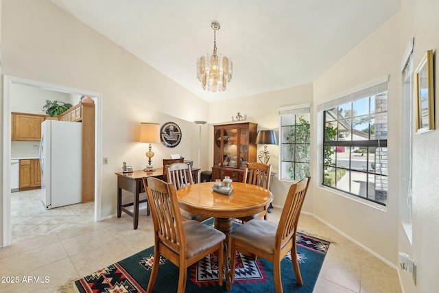 dining space with baseboards, a chandelier, light tile patterned flooring, and vaulted ceiling