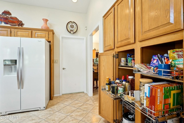 kitchen with light tile patterned floors and white refrigerator with ice dispenser