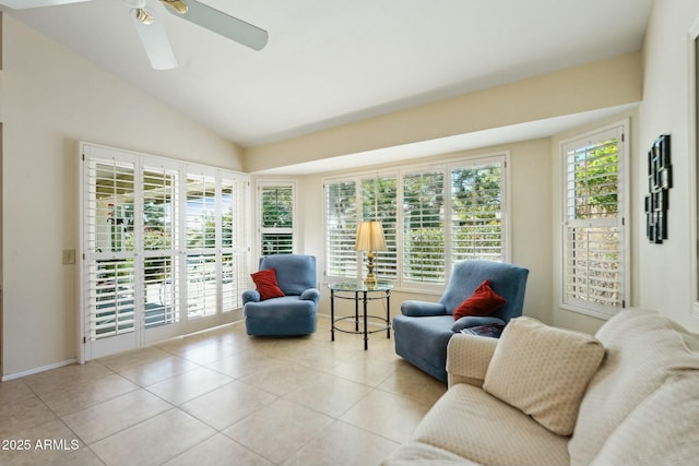 sunroom with vaulted ceiling, a ceiling fan, and a wealth of natural light