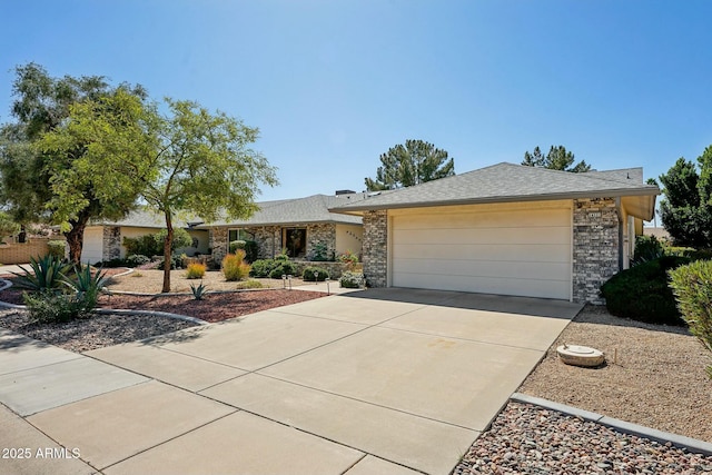 single story home with concrete driveway, a garage, and stone siding