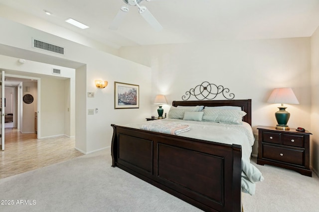 bedroom with lofted ceiling, a ceiling fan, visible vents, and light carpet