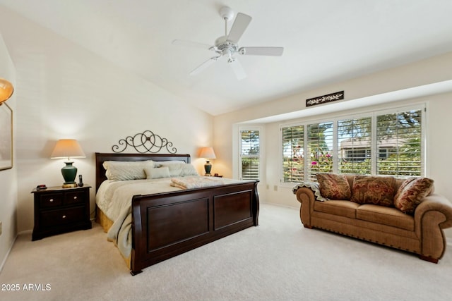 bedroom featuring vaulted ceiling, light colored carpet, and ceiling fan