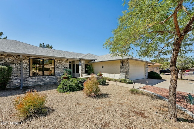 view of front facade with stone siding, driveway, and a garage