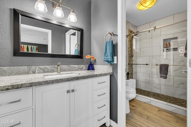 4116 E Downing St, Mesa, AZ 85205 - bathroom with vanity, a shower stall, a textured wall, and wood finished floors