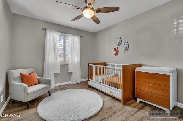 4116 E Downing St, Mesa, AZ 85205 - bedroom featuring wood finished floors, a nursery area, and a ceiling fan